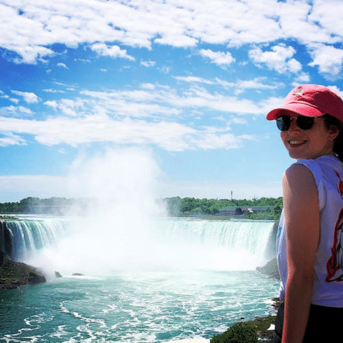 Photo of working holiday visa holder looking back at the camera from Niagara Falls