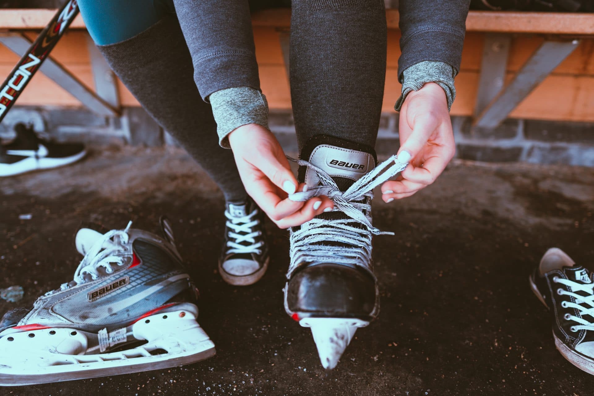 Photo of hockey player lacing up their skates