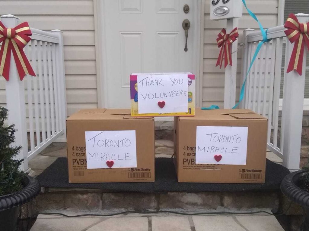 Brown boxes with white paper on them in front of a porch.