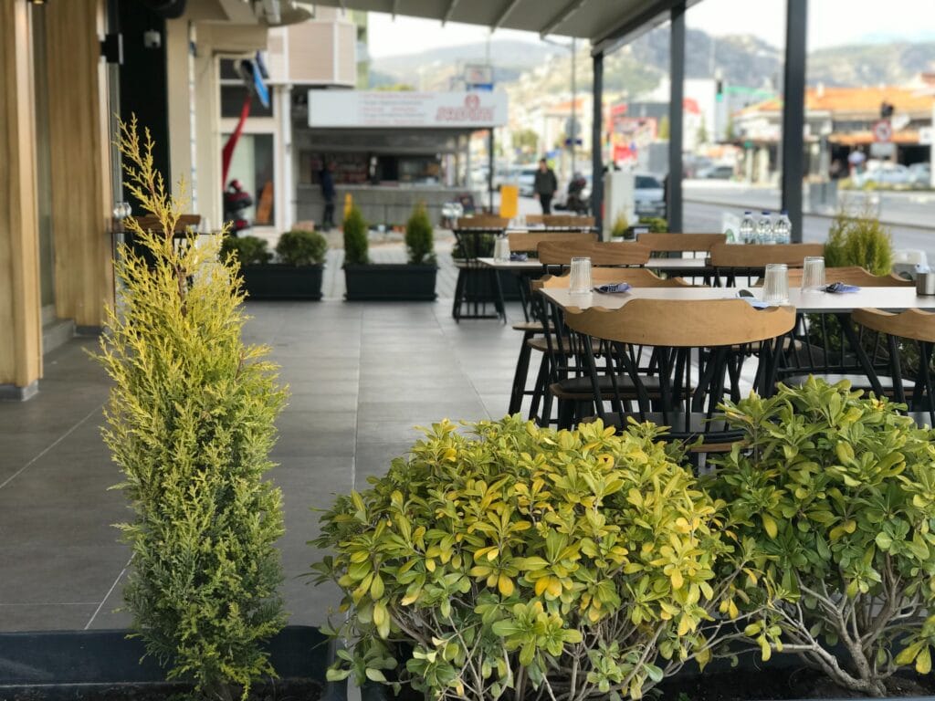 A row of tables outside a restaurant