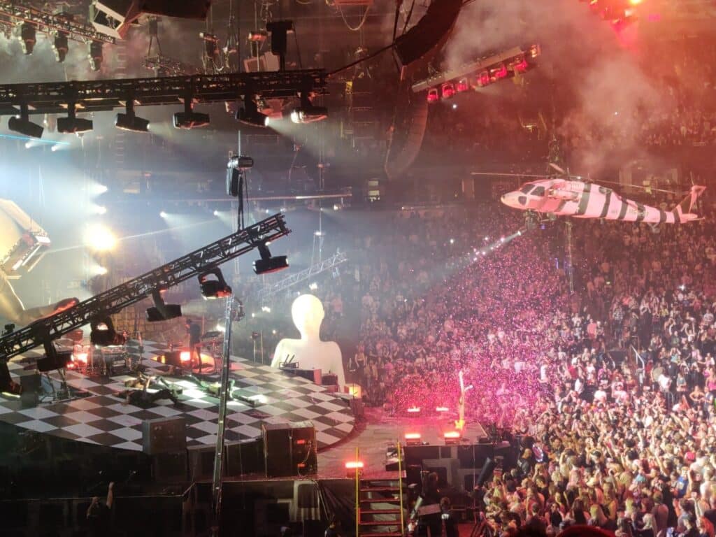 MGK flying into the stage on a prop helicopter